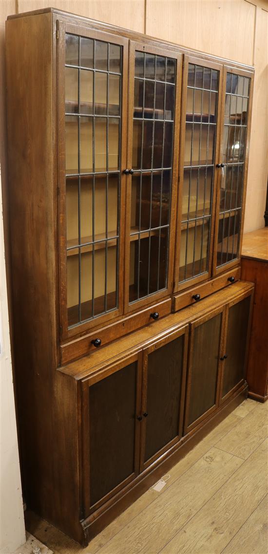 A 1920s oak library bookcase with leaded lights W.152cm